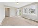 Bright living room features neutral carpet, fresh paint, and natural light at 3826 Delaware St, Anderson, IN 46013