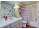 Inviting bathroom showcasing a vanity, toilet, and a shower/tub with a patterned curtain at 4013 Colonial Dr, Anderson, IN 46012