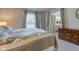 Comfortable bedroom with a window, stylish dresser, and a glimpse into an ensuite bathroom at 4013 Colonial Dr, Anderson, IN 46012
