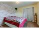 Cozy bedroom with a decorative wood-look accent wall and a comfortable-looking bed at 4013 Colonial Dr, Anderson, IN 46012