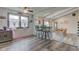 Cozy dining area with a breakfast bar, leading to a rustic dining table set for six at 4013 Colonial Dr, Anderson, IN 46012