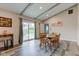 Open dining area with rustic wood table, slider to outside, and beamed ceiling; great space for gatherings at 4013 Colonial Dr, Anderson, IN 46012