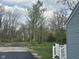 Backyard view showing the newly paved driveway, landscaping, and house siding at 410 S 25Th Ave, Beech Grove, IN 46107