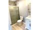 Well-lit bathroom with a marble-tiled shower, modern vanity, and neutral wall color at 410 S 25Th Ave, Beech Grove, IN 46107