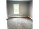 A gray bedroom with carpet, a window and white trim at 410 S 25Th Ave, Beech Grove, IN 46107
