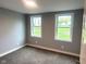 Bright bedroom with neutral walls, carpeting, and multiple windows for plenty of natural light at 410 S 25Th Ave, Beech Grove, IN 46107
