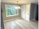 Inviting dining area featuring light wood floors, natural light, and convenient closet storage at 410 S 25Th Ave, Beech Grove, IN 46107