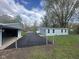 Home exterior with blue siding, a detached garage, and new asphalt driveway at 410 S 25Th Ave, Beech Grove, IN 46107