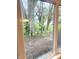 View from the window overlooking the backyard and lush trees in a natural outdoor setting at 410 S 25Th Ave, Beech Grove, IN 46107