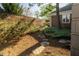 Well-maintained backyard with lush landscaping, stone path, and brick perimeter wall at 411 Sugar Tree Ln, Indianapolis, IN 46260