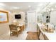 Bright bathroom with vanity, large mirrors, and a makeup table at 411 Sugar Tree Ln, Indianapolis, IN 46260