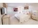 Comfortable bedroom with neutral tones, plush bedding, decorative artwork, and ample natural light at 411 Sugar Tree Ln, Indianapolis, IN 46260