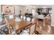 Spacious dining room with a long table, adjacent to a seating area featuring a baby grand piano at 411 Sugar Tree Ln, Indianapolis, IN 46260
