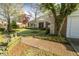 Charming single-story brick home featuring a lush front yard with mature trees and a welcoming entrance at 411 Sugar Tree Ln, Indianapolis, IN 46260