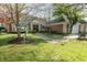 Charming home featuring a lush lawn, brick facade, and artistic bronze statues in the front yard at 411 Sugar Tree Ln, Indianapolis, IN 46260