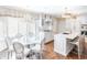 Bright kitchen with marble counters, a large island with seating, custom cabinets, and a dining nook at 411 Sugar Tree Ln, Indianapolis, IN 46260