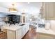 Spacious kitchen featuring custom cabinets, a marble countertop island, and an open view to the breakfast room at 411 Sugar Tree Ln, Indianapolis, IN 46260