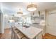 Bright kitchen featuring a marble island, modern pendant lighting, and custom cabinetry at 411 Sugar Tree Ln, Indianapolis, IN 46260