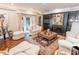 Cozy living room with a fireplace, plush seating, and access to the outdoor area at 411 Sugar Tree Ln, Indianapolis, IN 46260