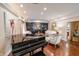 Open living space featuring a piano, built-in cabinets, and neutral-toned furniture at 411 Sugar Tree Ln, Indianapolis, IN 46260