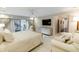 Serene main bedroom featuring a king bed, carpet, a large TV, and sliding glass doors to the backyard at 411 Sugar Tree Ln, Indianapolis, IN 46260
