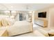 Neutral main bedroom featuring a king bed, soft carpet, a large TV, and sliding glass doors to the backyard at 411 Sugar Tree Ln, Indianapolis, IN 46260