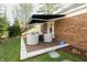 Inviting patio with brick pavers, comfortable seating, and a retractable awning for shade at 411 Sugar Tree Ln, Indianapolis, IN 46260