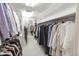 Bright walk-in closet features custom shelving and ample storage space for clothing and accessories at 411 Sugar Tree Ln, Indianapolis, IN 46260