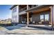 Spacious back porch with brick columns, wooden ceiling, and modern furniture at 4292 Alderborough Way, Zionsville, IN 46077