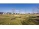 View of backyard overlooking the golf course with sand traps and newly planted trees at 4292 Alderborough Way, Zionsville, IN 46077