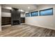 Finished basement with fireplace, built-in bookshelves, and natural light at 4292 Alderborough Way, Zionsville, IN 46077