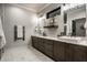 Elegant bathroom featuring double vanity with stone countertop, modern fixtures, and marble flooring at 4292 Alderborough Way, Zionsville, IN 46077