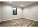 Empty bedroom with wood grain floors and natural light from single window at 4292 Alderborough Way, Zionsville, IN 46077