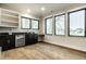 A bonus room featuring a bar with a built-in wine fridge and dark granite countertops at 4292 Alderborough Way, Zionsville, IN 46077
