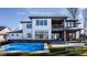 Stunning two-story home featuring a sparkling pool, covered patio, and modern architectural details at 4292 Alderborough Way, Zionsville, IN 46077