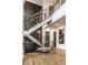 Grand foyer with elegant staircase, wood floors, wainscoting, designer decor, and natural light, creating a welcoming atmosphere at 4292 Alderborough Way, Zionsville, IN 46077