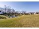 View of a serene pond and golf course within the community at 4292 Alderborough Way, Zionsville, IN 46077