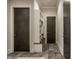 Hallway features dark wood doors, stylish floor tiles, and a built-in bench with shelving for storage at 4292 Alderborough Way, Zionsville, IN 46077