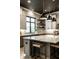 Bright kitchen with an island and modern pendant lighting fixtures, accompanied by stone countertops and backsplash at 4292 Alderborough Way, Zionsville, IN 46077