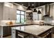 Kitchen island with seating and quartz countertops, stainless steel appliances, and modern backsplash at 4292 Alderborough Way, Zionsville, IN 46077