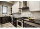 Modern kitchen with white subway tile backsplash, dark countertops, and stainless steel appliances at 4292 Alderborough Way, Zionsville, IN 46077