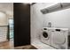 Bright laundry room with Miele washer and dryer, and sliding barn door at 4292 Alderborough Way, Zionsville, IN 46077