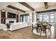 Spacious living area showcasing modern furniture, exposed beams, and seamless transition to dining space at 4292 Alderborough Way, Zionsville, IN 46077