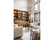 Modern living room highlighting built-in wooden cabinets, high ceilings, and comfortable seating at 4292 Alderborough Way, Zionsville, IN 46077