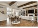 Open concept living room with a modern fireplace, lots of light, wood beams and an open floorplan at 4292 Alderborough Way, Zionsville, IN 46077