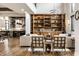 Open concept living room showcasing built-in wood cabinets, modern lighting, and hardwood floors at 4292 Alderborough Way, Zionsville, IN 46077
