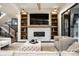 Bright living room featuring a stone fireplace with built-in shelving and comfortable seating arrangements at 4292 Alderborough Way, Zionsville, IN 46077