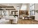 Bright open-concept living room with tall windows, wood floors, beamed ceilings, and modern decor at 4292 Alderborough Way, Zionsville, IN 46077