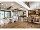Expansive open-concept living room featuring wood floors, beamed ceilings, and stylish modern furniture at 4292 Alderborough Way, Zionsville, IN 46077