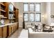 Stylish living room with built-in cabinets, modern lighting, and comfortable seating on hardwood floors at 4292 Alderborough Way, Zionsville, IN 46077
